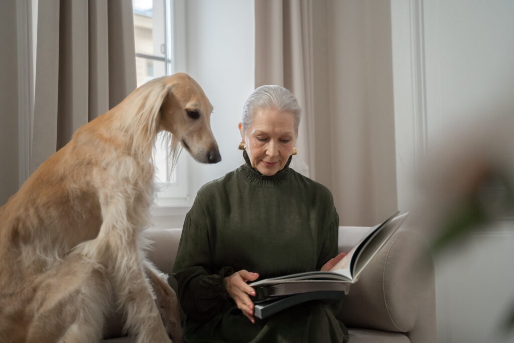 dog and woman reading book